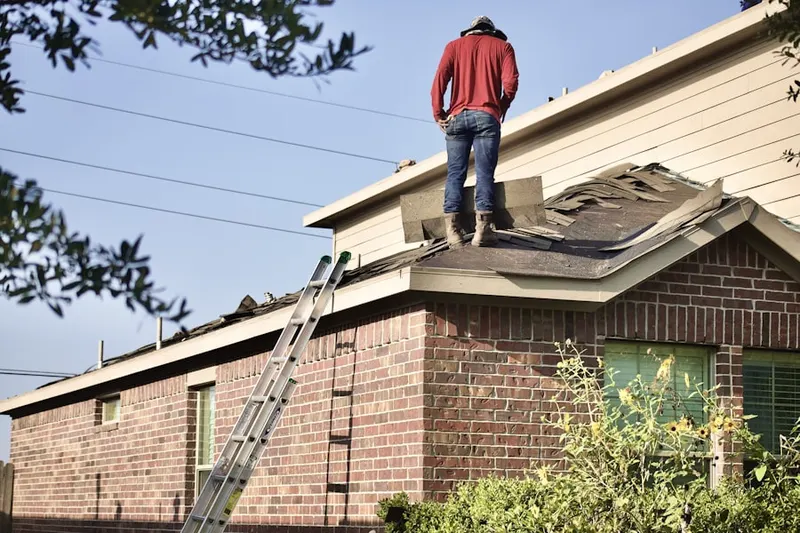 Professional roofer working on a residential roof in White